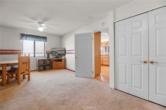 interior space featuring ceiling fan and a closet