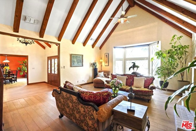 living room featuring beamed ceiling, high vaulted ceiling, and light hardwood / wood-style flooring