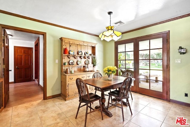 dining space with french doors, light hardwood / wood-style floors, and crown molding