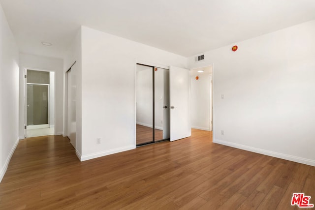 unfurnished bedroom featuring hardwood / wood-style flooring