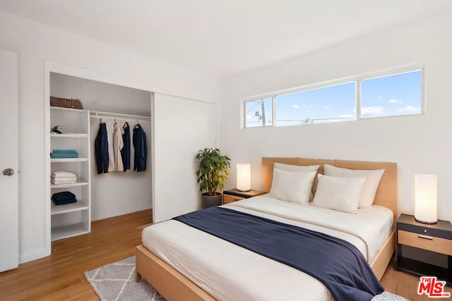 bedroom featuring a closet and light hardwood / wood-style floors