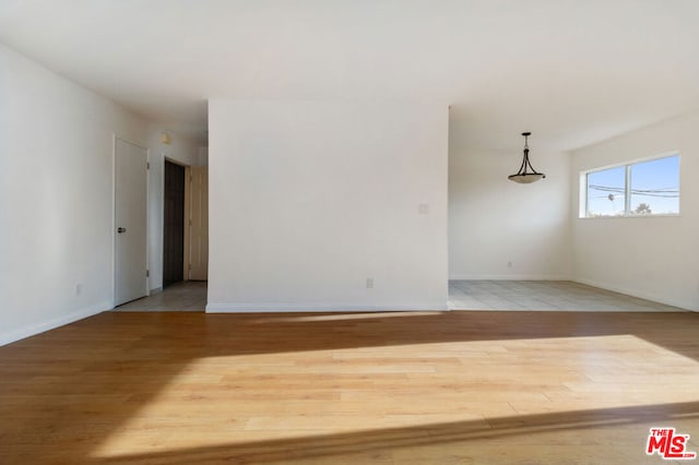 empty room with hardwood / wood-style flooring