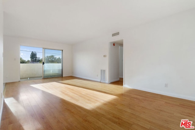 unfurnished room with light hardwood / wood-style floors