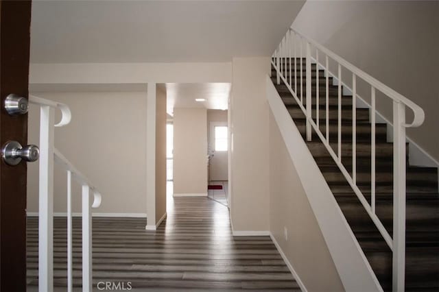 stairs featuring hardwood / wood-style flooring