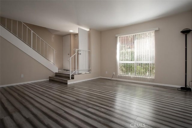 unfurnished living room featuring dark wood-type flooring