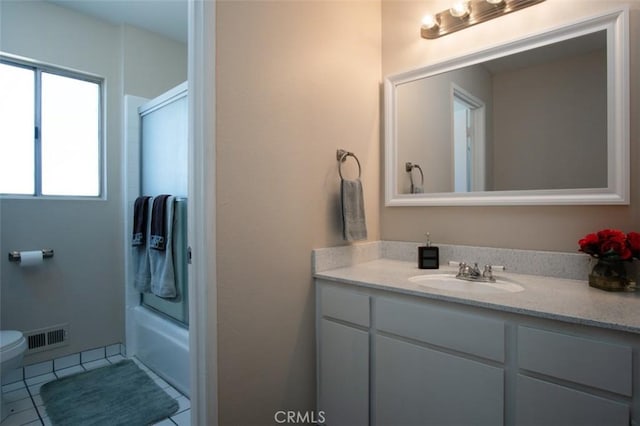 full bathroom with tile patterned flooring, vanity, toilet, and shower / bath combination with glass door