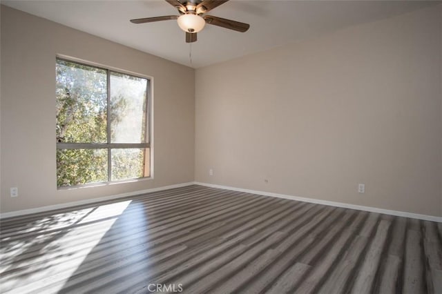 unfurnished room featuring ceiling fan, plenty of natural light, and dark hardwood / wood-style floors