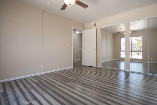 unfurnished bedroom with ceiling fan and dark hardwood / wood-style flooring