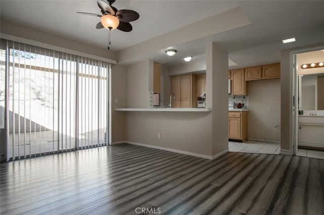 unfurnished living room featuring light hardwood / wood-style flooring and ceiling fan