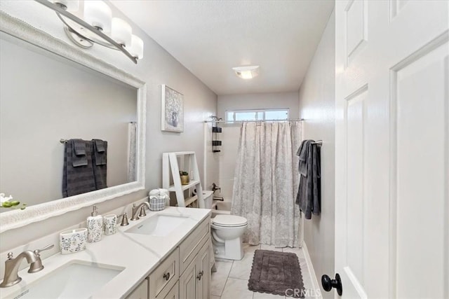 full bathroom featuring vanity, tile patterned floors, shower / bath combination with curtain, toilet, and a textured ceiling