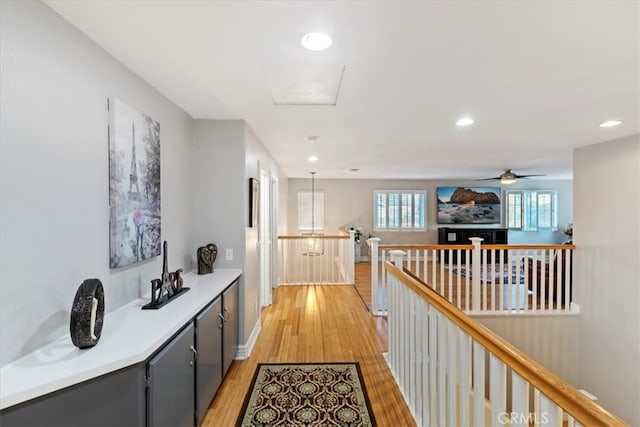 corridor with light hardwood / wood-style floors