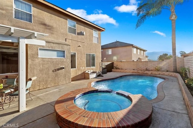 view of swimming pool featuring an in ground hot tub and a patio