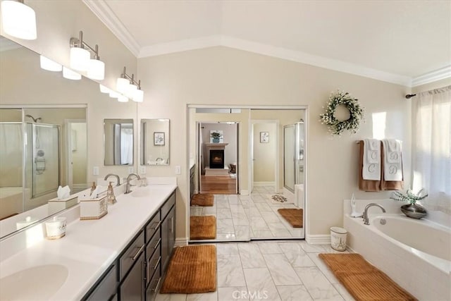 bathroom featuring plus walk in shower, ornamental molding, vanity, and lofted ceiling