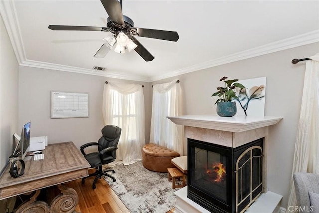 home office with hardwood / wood-style flooring, ceiling fan, and crown molding