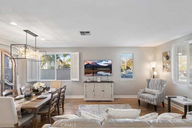 living room featuring a chandelier and hardwood / wood-style flooring