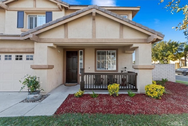 view of front of home featuring a porch and a garage