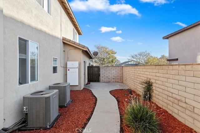 view of yard with central AC unit and a patio