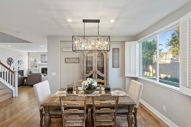 dining room with an inviting chandelier and light hardwood / wood-style flooring