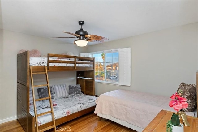 bedroom with ceiling fan and hardwood / wood-style flooring