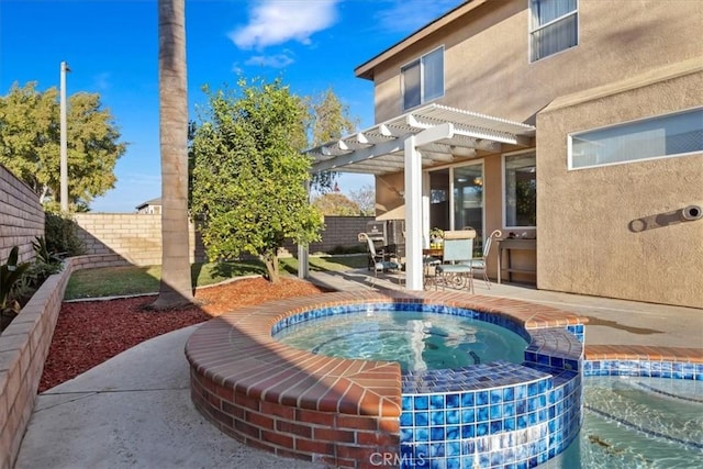 view of patio / terrace with a pergola and an in ground hot tub