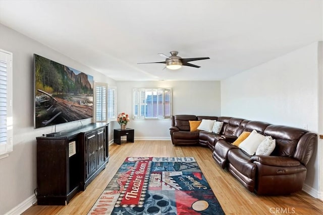 living room with ceiling fan and light hardwood / wood-style floors