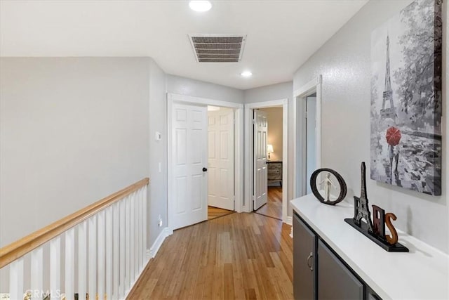 hallway with light hardwood / wood-style flooring