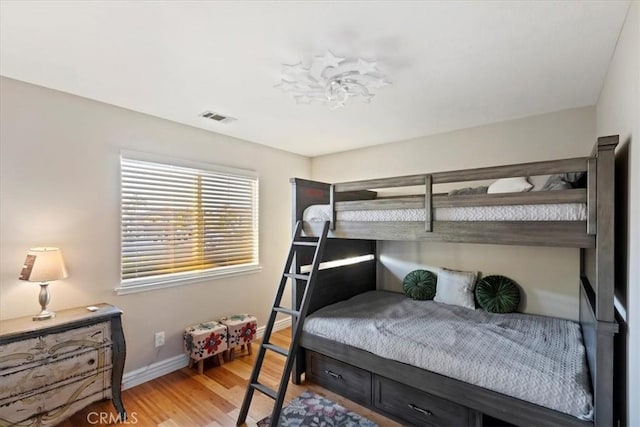 bedroom with hardwood / wood-style flooring