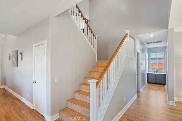 staircase featuring wood-type flooring