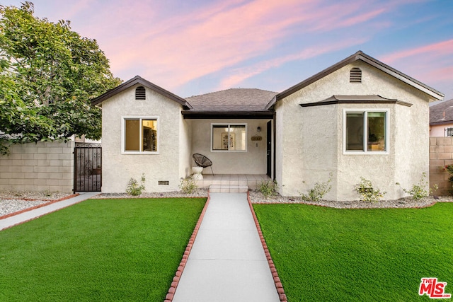 bungalow-style house with a lawn