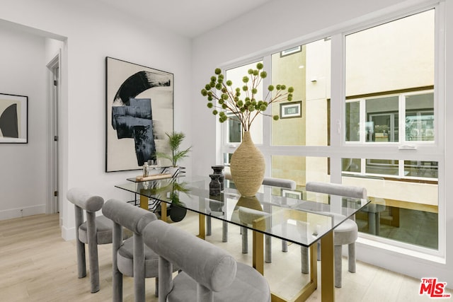 dining area featuring a wealth of natural light and light hardwood / wood-style floors