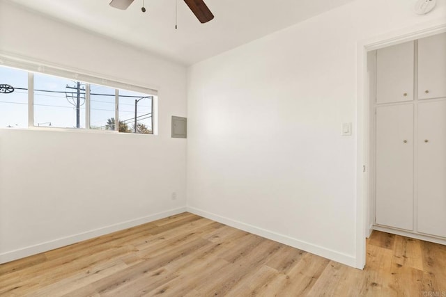 empty room with ceiling fan and light wood-type flooring