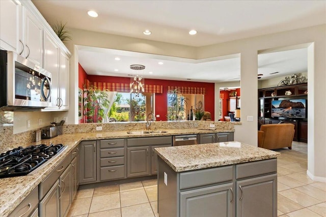 kitchen featuring stainless steel appliances, sink, pendant lighting, white cabinets, and gray cabinets