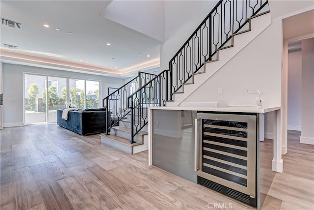 interior space with wine cooler and light hardwood / wood-style flooring