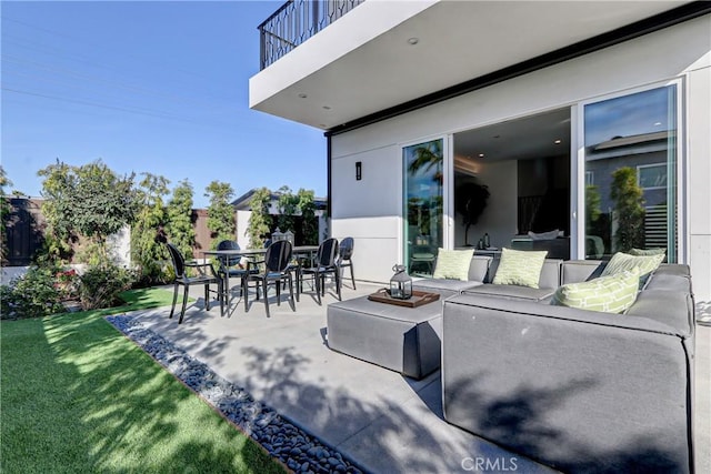 view of patio with a balcony and an outdoor hangout area