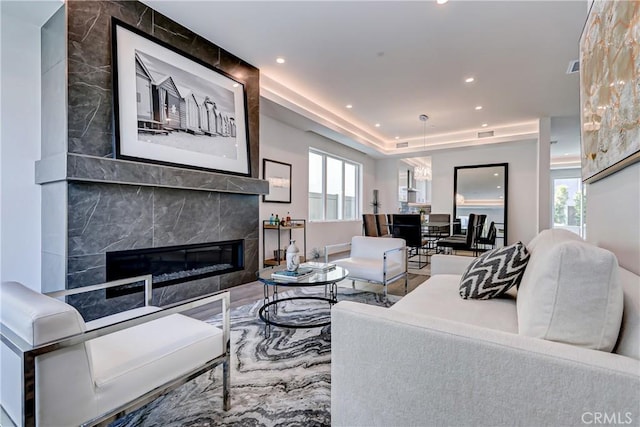 living room with a tile fireplace