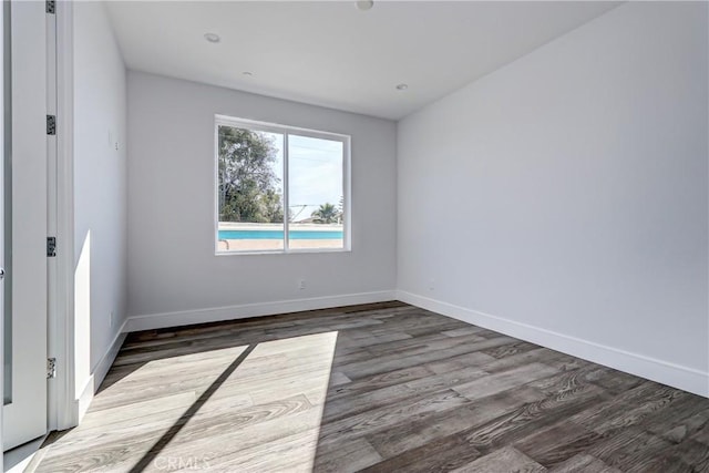 empty room featuring dark wood-type flooring