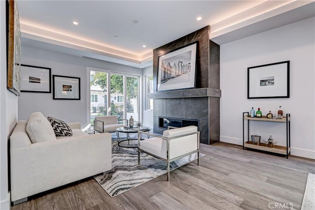 living room with light hardwood / wood-style floors and a fireplace