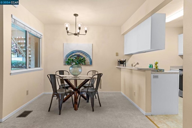 carpeted dining space featuring a notable chandelier