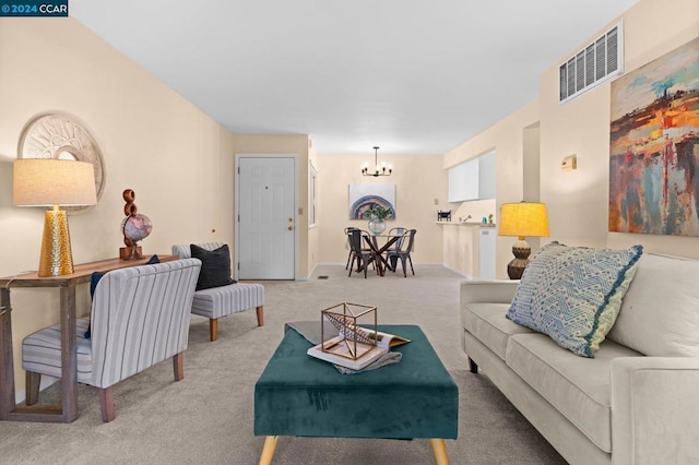 carpeted living room with an inviting chandelier