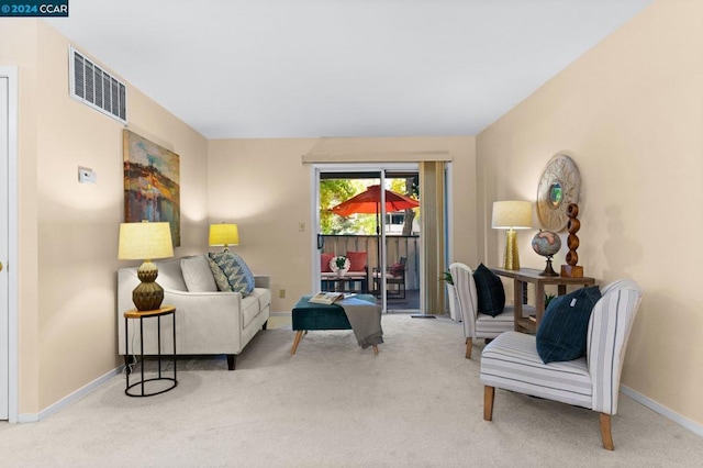 sitting room featuring light colored carpet