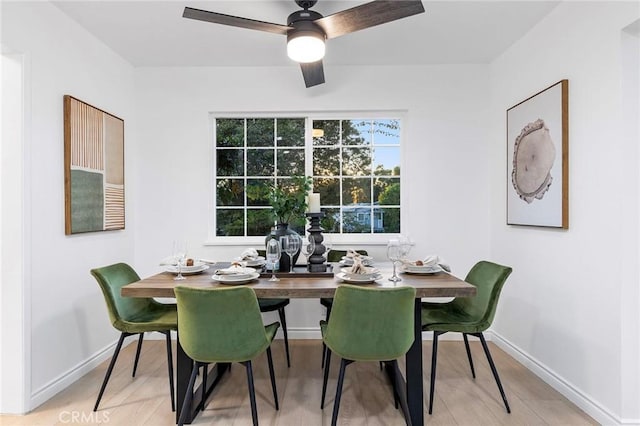 dining space featuring light wood-type flooring and ceiling fan