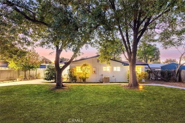 exterior space with a lawn and central AC