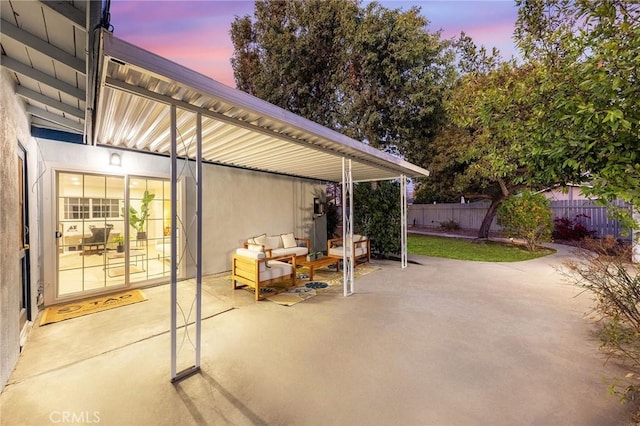 patio terrace at dusk featuring outdoor lounge area