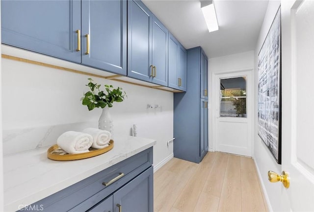 washroom featuring cabinets, washer hookup, and light wood-type flooring