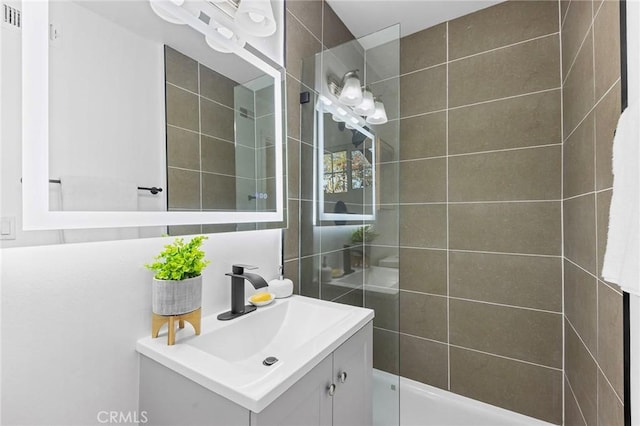 bathroom featuring vanity and a tile shower