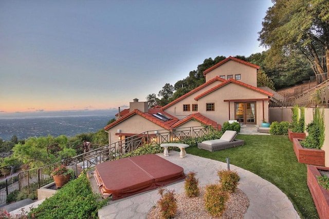 exterior space featuring a covered hot tub and a patio