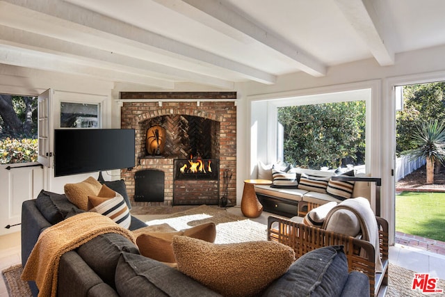 interior space featuring beamed ceiling and a brick fireplace