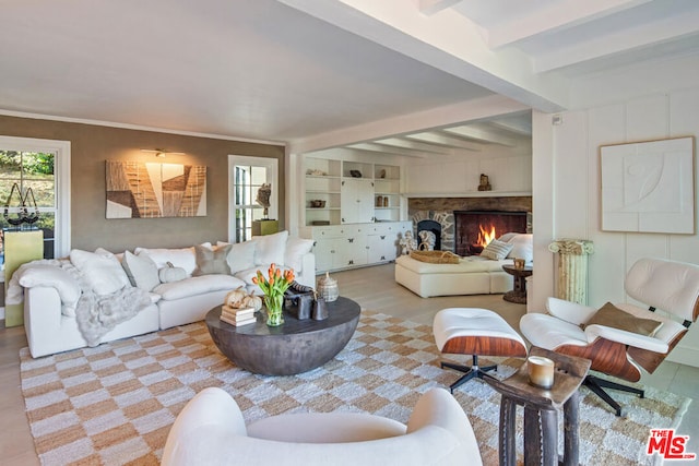 living room featuring beam ceiling and ornamental molding