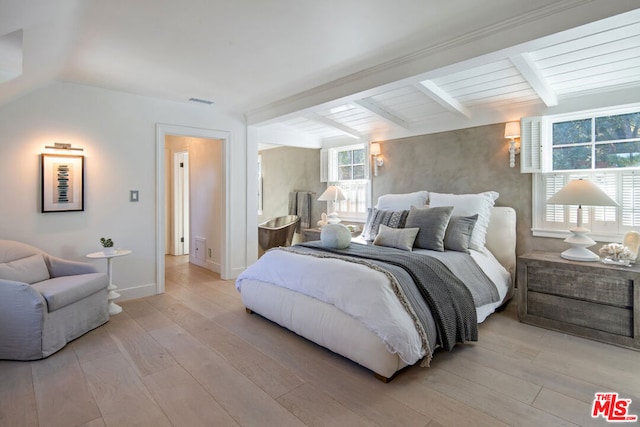 bedroom with vaulted ceiling with beams, light hardwood / wood-style floors, and wooden ceiling