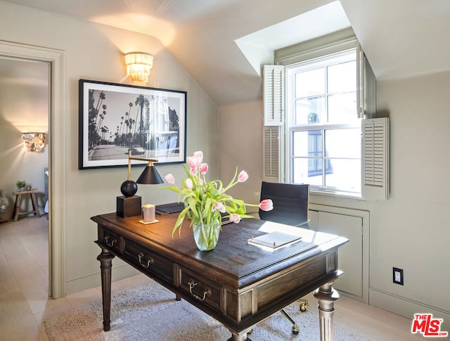 office area with plenty of natural light and lofted ceiling